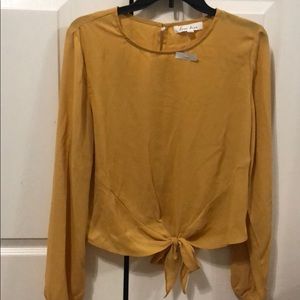 NWT Beautiful FALL mustard blouse with tie bottom!